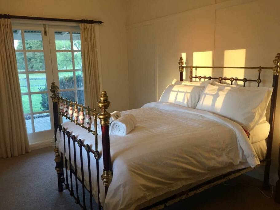 Sunset rays across brass bed: Third Bedroom
