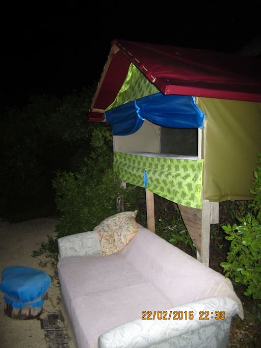 king size undulating stilt bed overlooking water and rising sun
