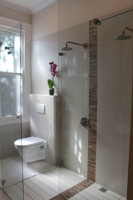 En suite bathroom with double shower and his and hers basins.