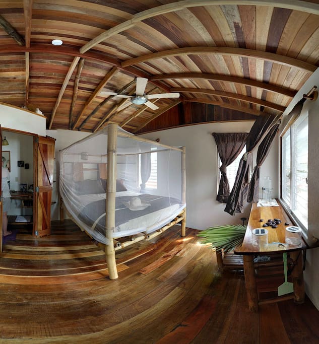 Gales Point artisans crafted this bungalow's furnishings from the bamboo that readily grows along local rivers. Decorated in greens, beiges and splashes of purple, this bamboo bungalow shines! Surround netting falls over a new queen-sized bed, and ceiling fans cool the room. There is shelving, desk and a safe for storing valuables. Hardwood floor, privacy window coverings and large bath with beautiful glass bowl sink and shower accented with glass tiles.