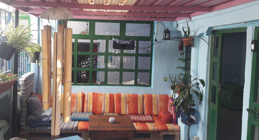 Double bedroom in a ethnic style house with garden