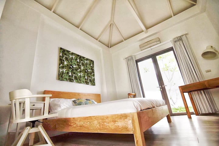 Balinese Teak King Bed and Tropical Art with a private garden courtyard. 