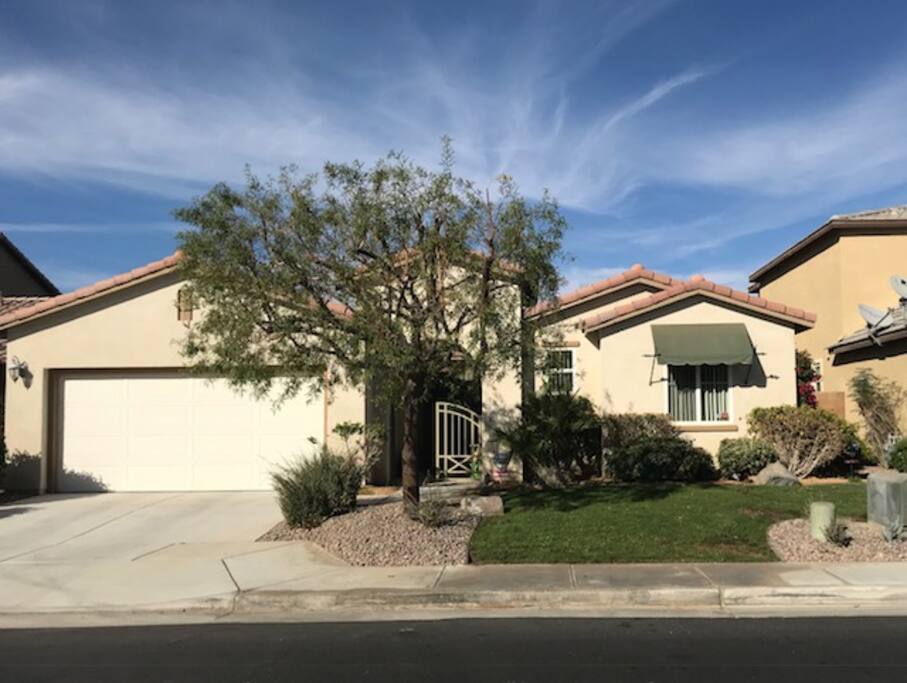 Front of the home with private courtyard entry