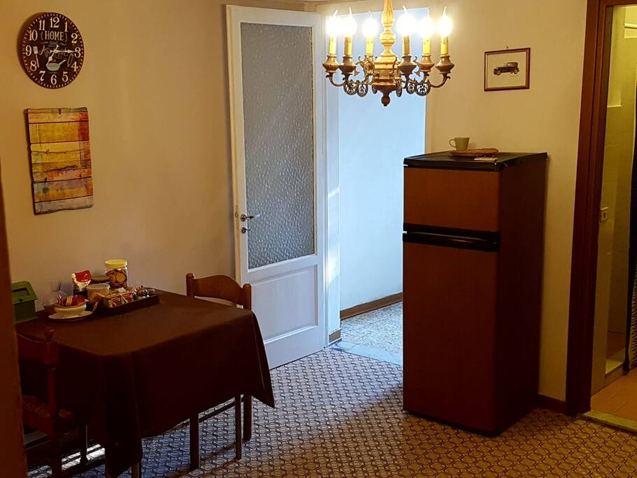 Dining room- table. breakfast on it. fridge, microwave, mocca and things for cooking