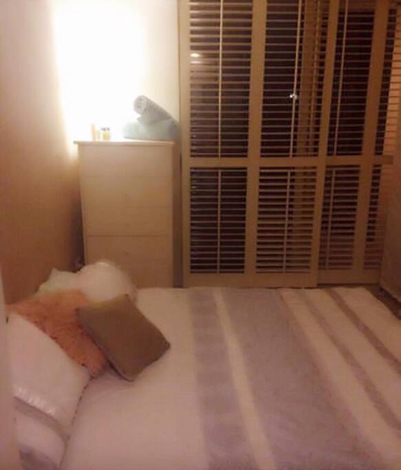 The guest room King size bed fresh linen professionally laundered after each guests stay access to the garden court yard chest of drawers hanging space and shoe space