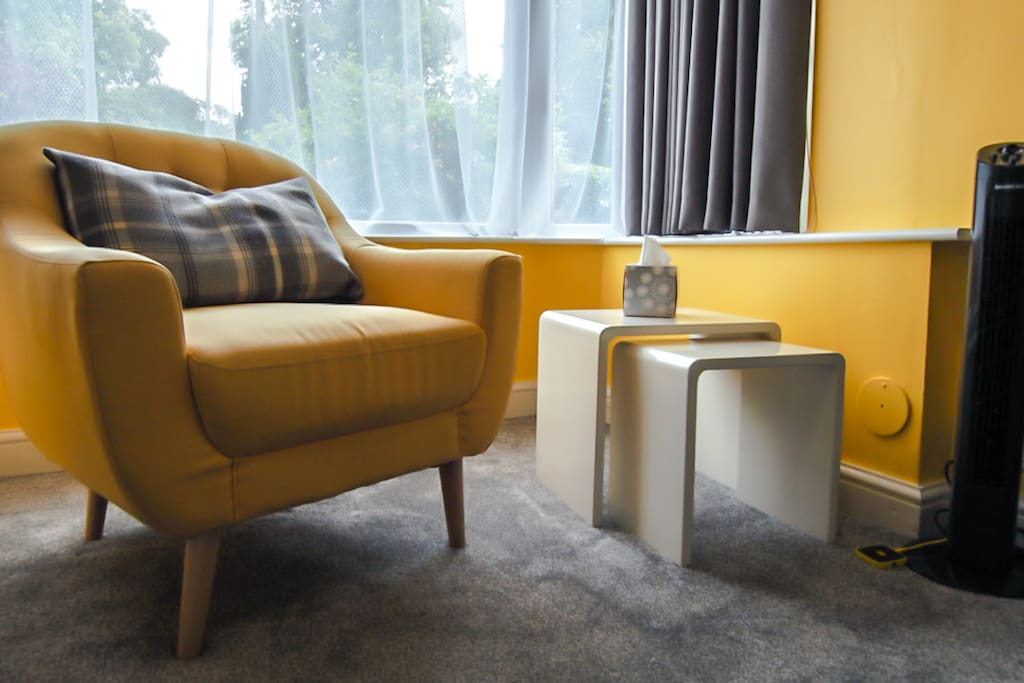 Relax in the bay window of the sunny spacious lounge with tower fan and USB sockets