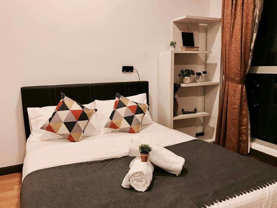 Comfortable queen-sized bed with bedding.