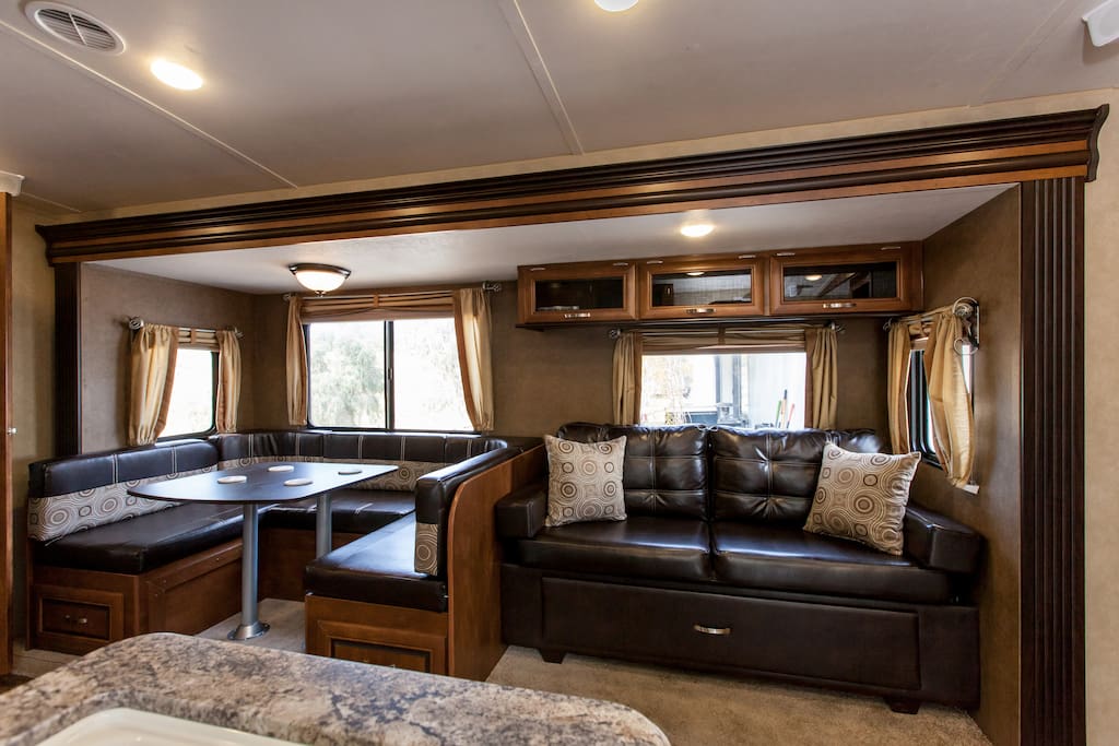 Leather Couch hide-a-bed w/storage below, Dining Table also converts to a double bed
