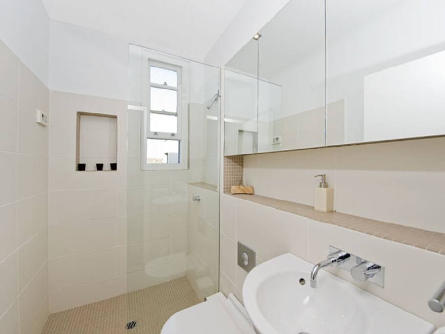 Light, stylish designer bathroom with mosaic-tile finishes.