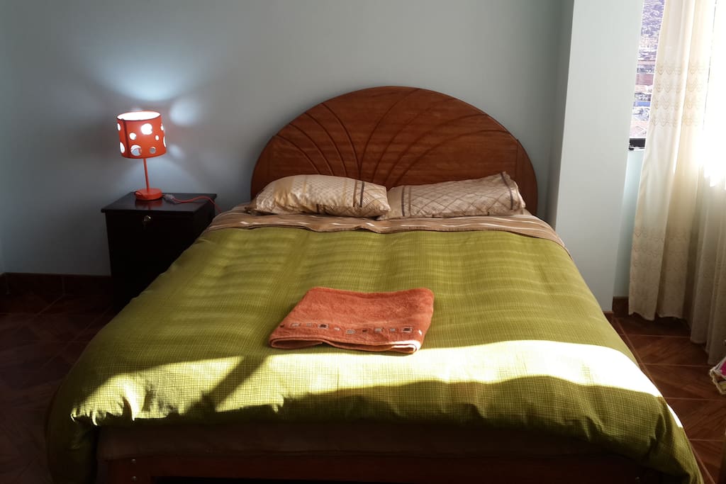 The same bedroom with a different bed cover