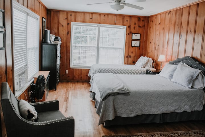 Large bedroom with a queen bed and twin bed. This bedroom is on the opposite side of the house from the other two bedrooms. This bedroom has an ensuite bathroom. It is accessed through the dining room.