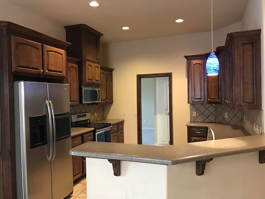 Kitchen with plenty of dishes, pots, pans for you me use.