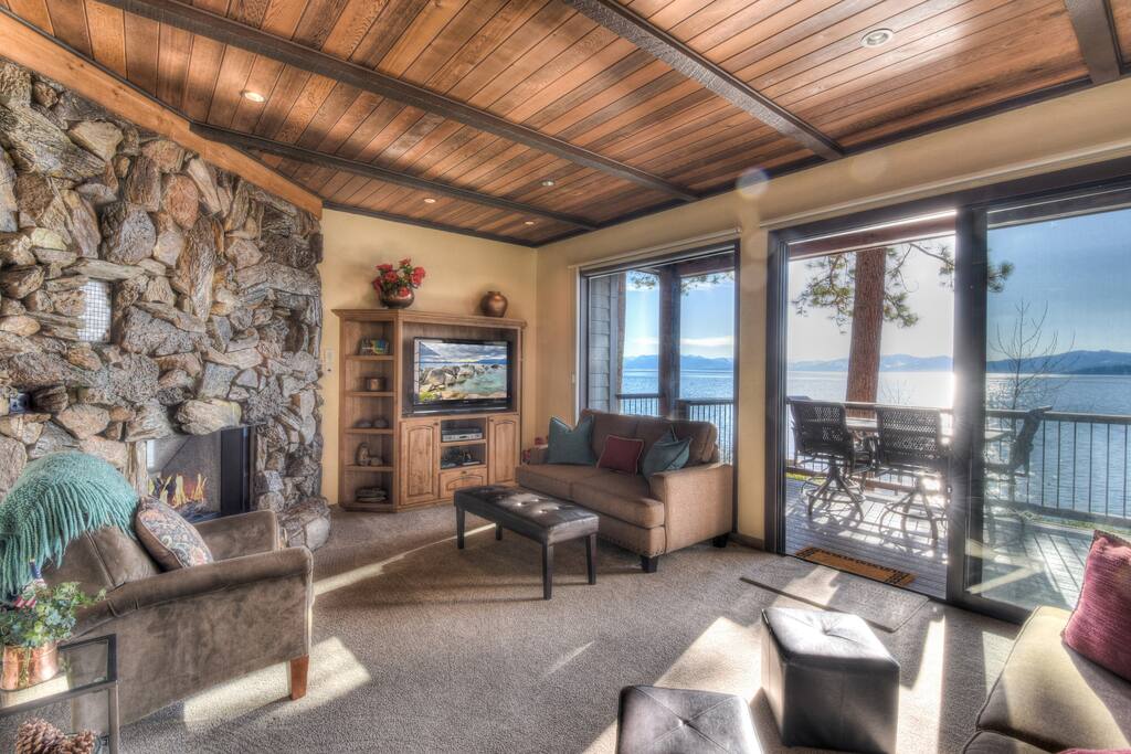 Beautiful living room with a gas fireplace and expansive lake views