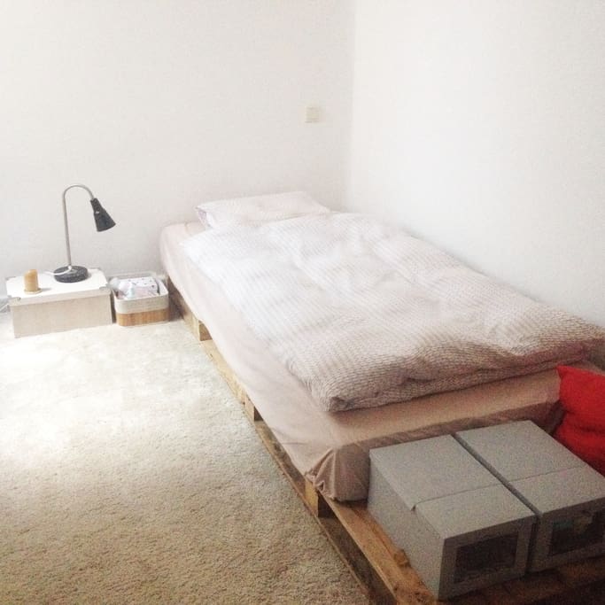 Bedroom with individual mattress, night light, and hanging closet