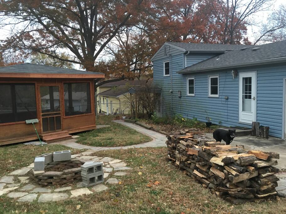Back yard: screened-in porch, firepit, kitchen door.