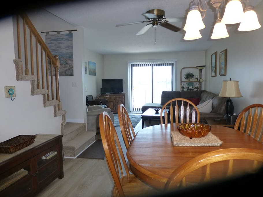Living room and dining room area with deck overlooking the Assawoman Bay in Ocean City