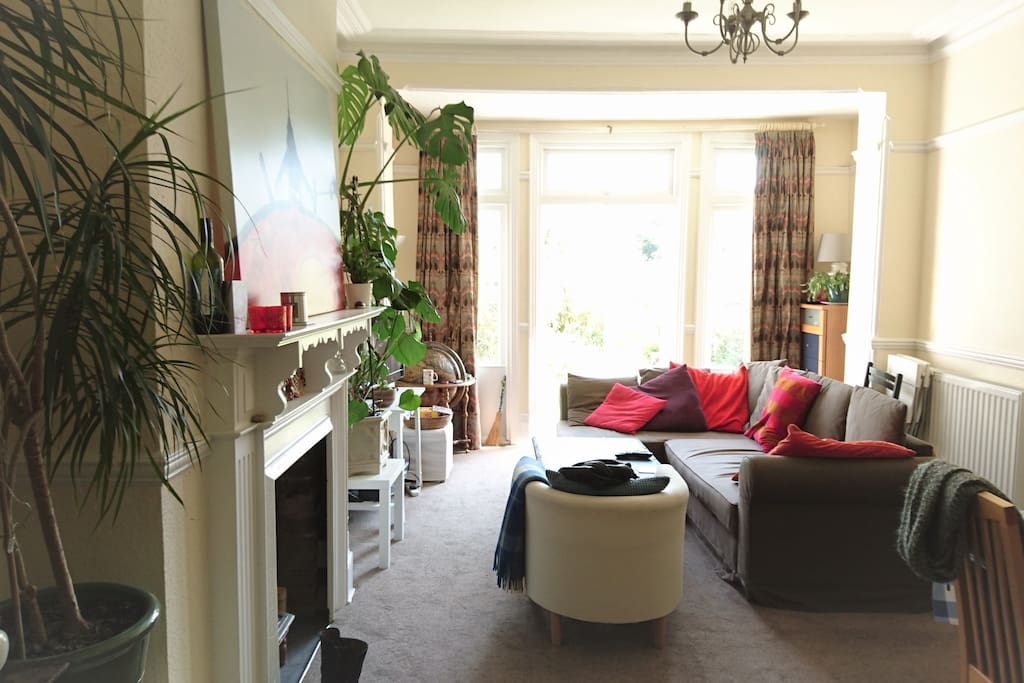 large bright living room with French windows onto patio/garden