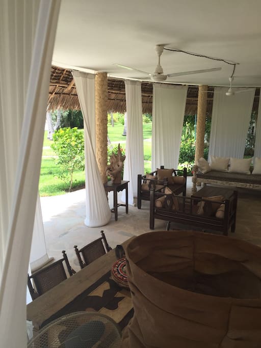 Veranda where you can relax and dine with pool and garden view.
