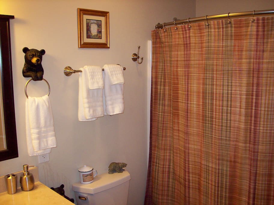 Single marble sink vanity, tub/shower combo, tile floor