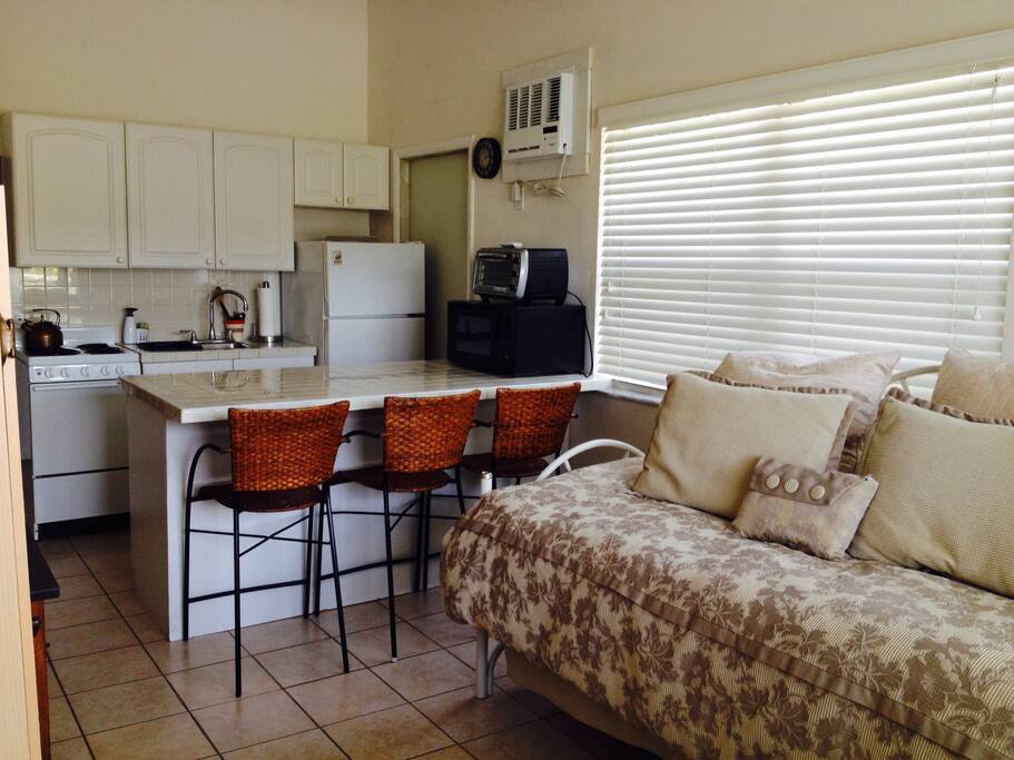 Daybed with trundle underneath, breakfast area with seats, and kitchen area.
This is the view as you walk in through your private entrance.
