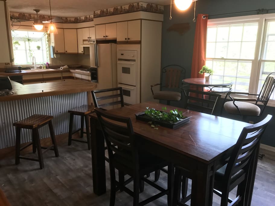 Dining room and kitchen with all the cooking utensils and oven space you'll ned.