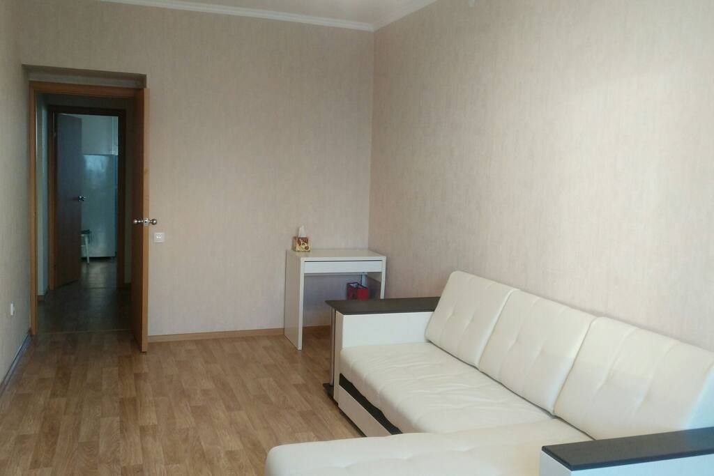 Living room with convertible sofa-bed and computer table.