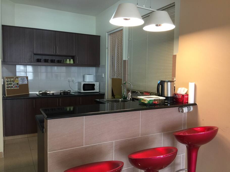 Kitchen with stove, toaster, microwave and kettle