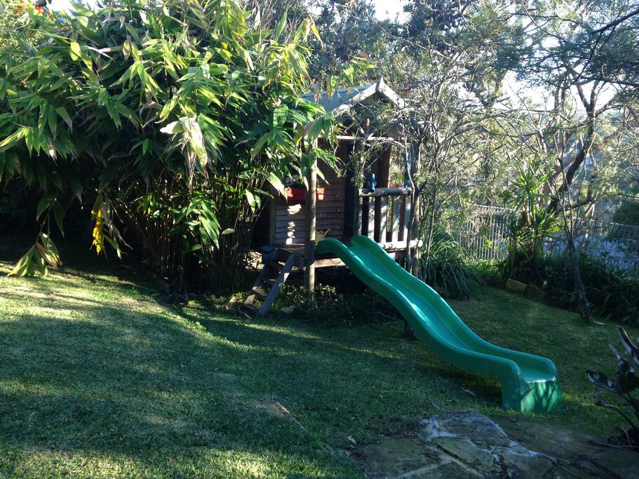 Outdoor cubby house with indoor kitchen and complete with slide, post box and pulley system for "packages" = hours of fun and entertainment.