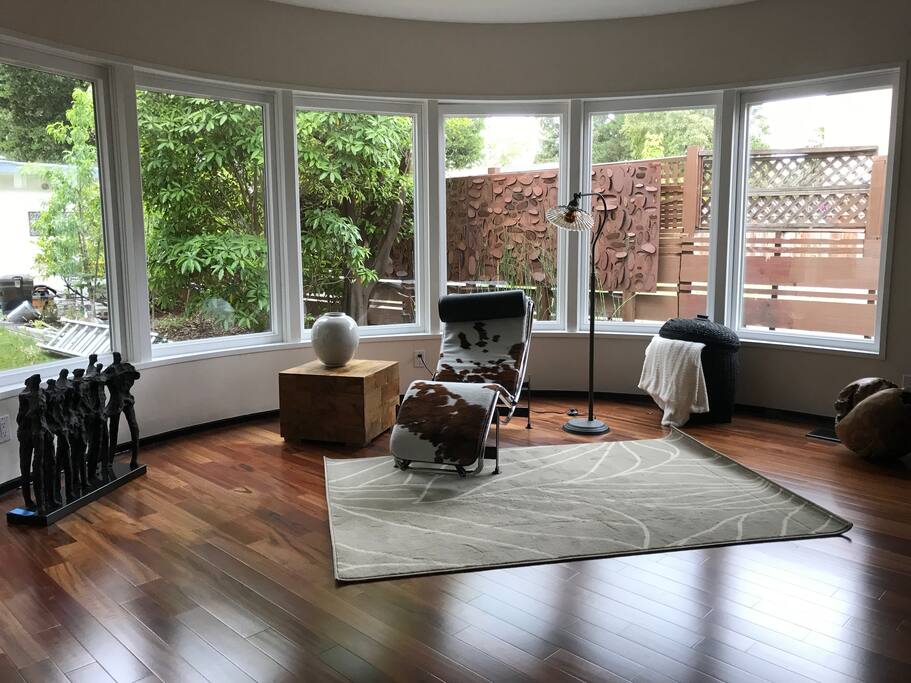 The curved side of the living room is a great place to read a book while looking out at the yard