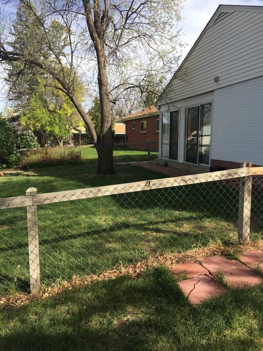 Here is the North side of my home where Guests will have there own entrance through the sliding glass doors. The fenced in back yard is also shown here where guests can sit and enjoy some outside time.
