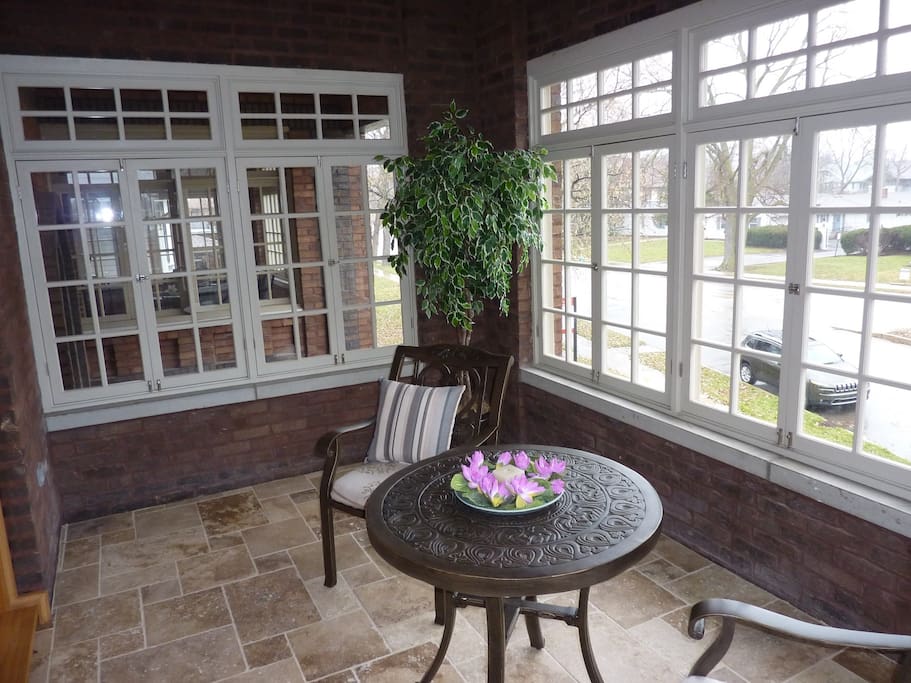 Windowed front porch. Great place to sit in the sun or catch a breeze.