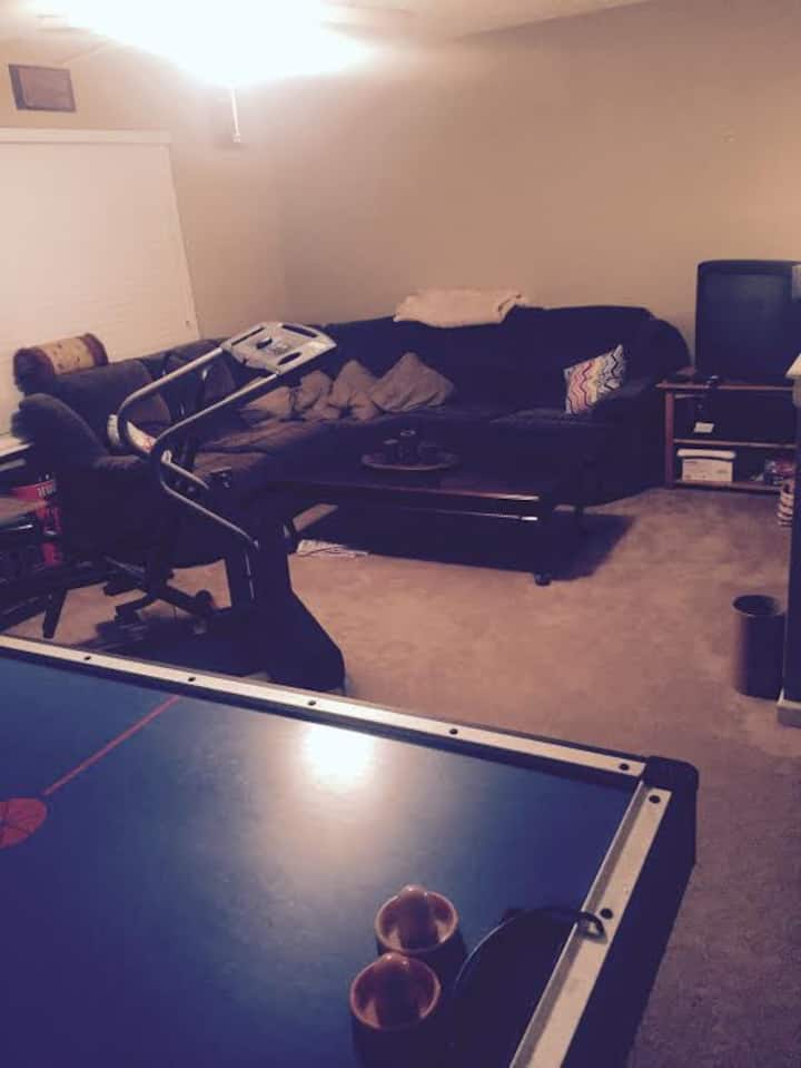 Upstairs Loft/Rec room/game & 40” tv room. Large sectional couch that could sleep two. Air hockey and Treadmill in this room. Darts as well but not shown. 40” tv with Netflix and Amazon Video