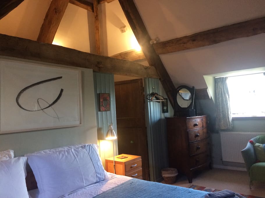 The bedroom with original exposed oak frame