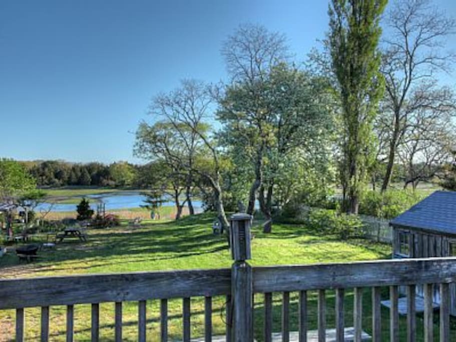 Deck over looking common areas. View of Marsh, gardens, picnic tables and hammock.