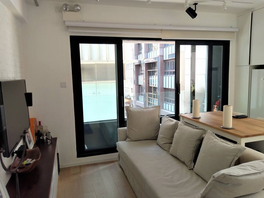Living/Kitchen with doors that open onto a small balcony