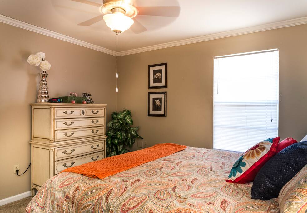Queen bedroom with dresser and closet.