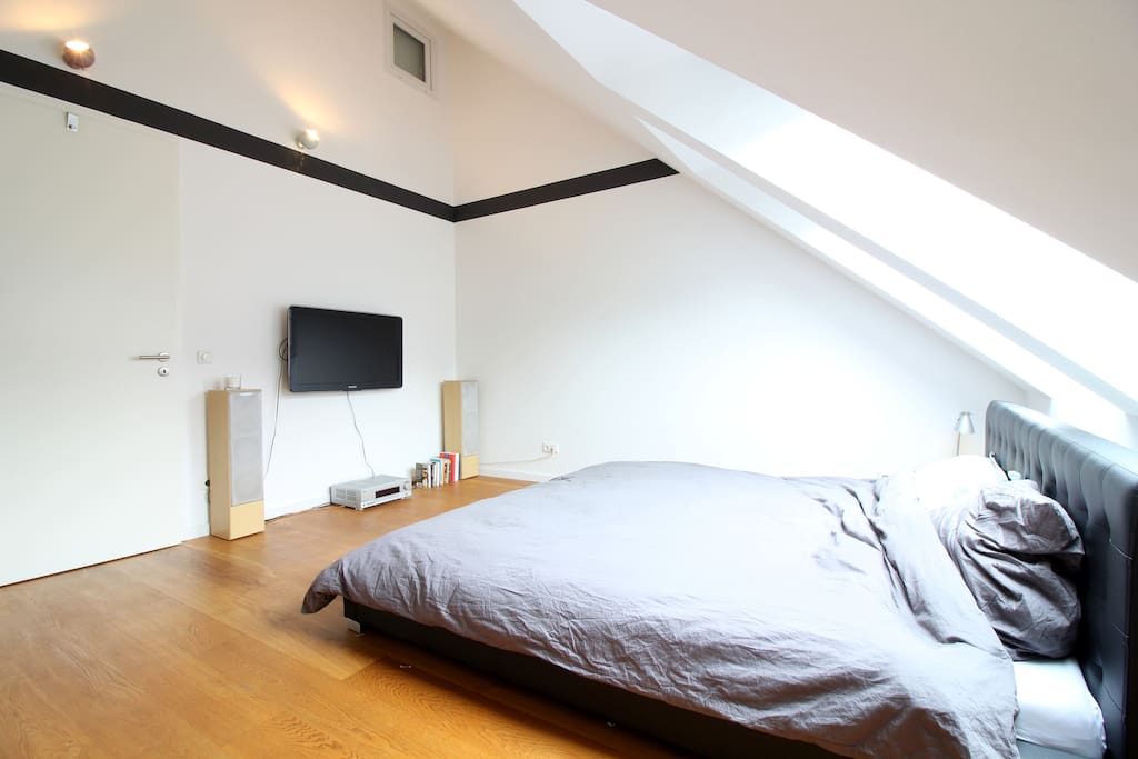 The bedroom is bright with a modern design.