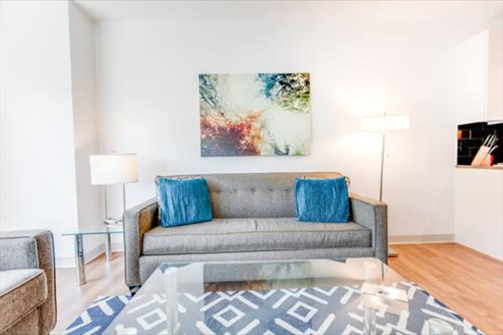 Comfortable living area with pullout sofa bed, and club chair