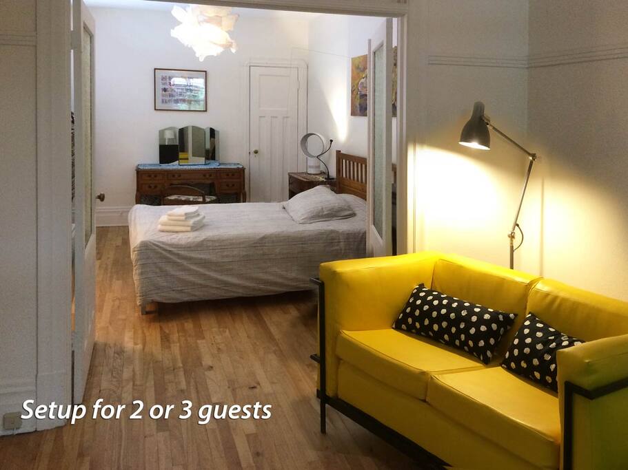 Bedroom and sitting room with small couch and bed (setup for 2 guests)