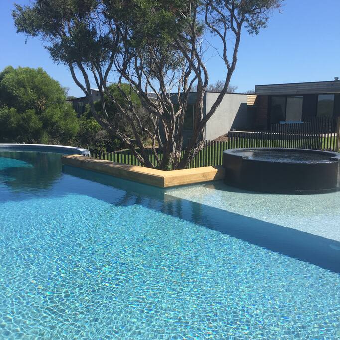 17 metre pool with spa, shallow paddling area and 3 m deep end. View toward house with rolling lawn area.