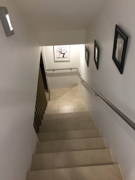 Stairs to the Lower level of the unit which includes bathroom and toilets