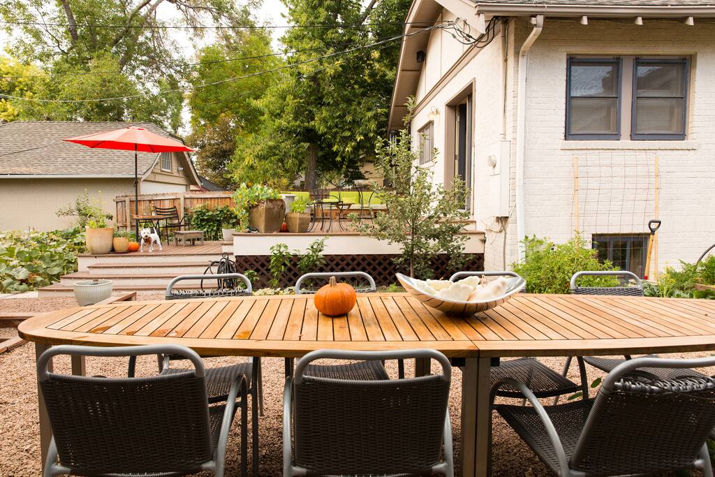 Backyard with outdoor living room, al fresco dining area, grill and organic vegetable and herb gardens.