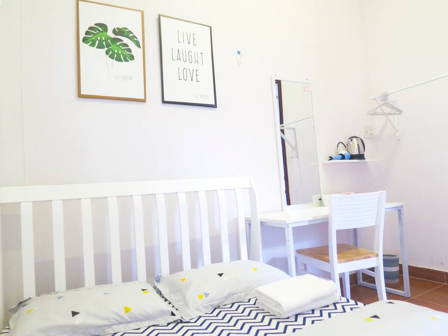 There are towels, table and chair, hanger, dryer
