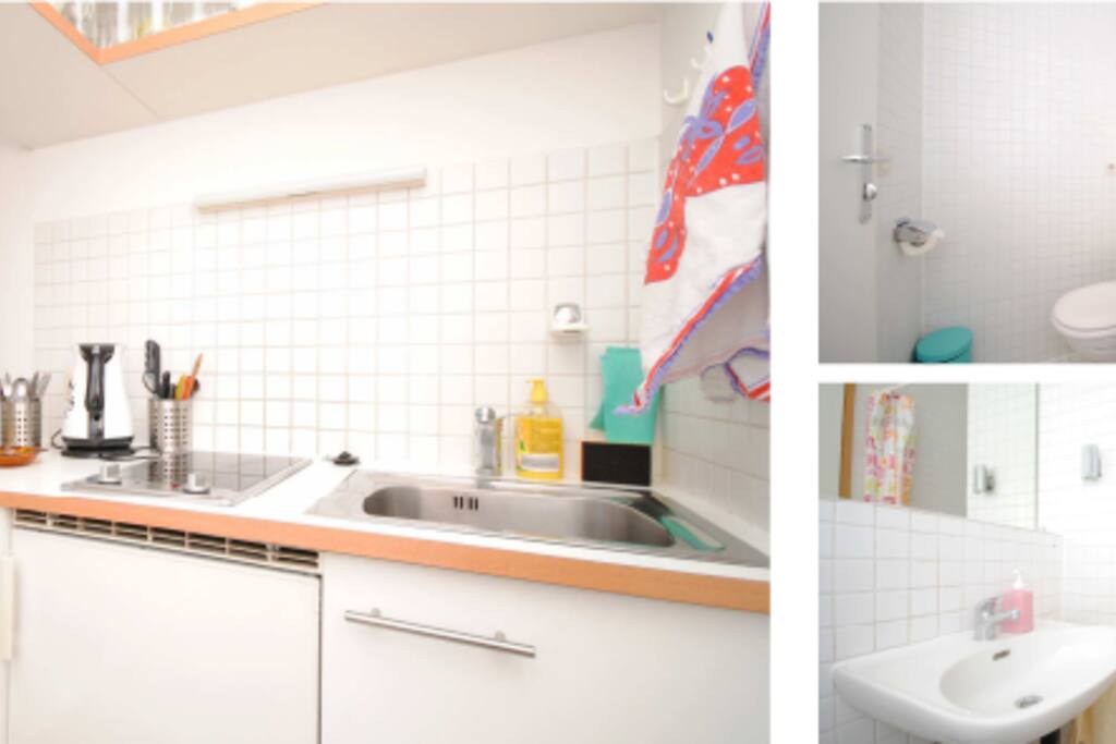 A clean kitchenette & a modern bathroom.