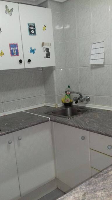 Kitchen with coffee maker, fridge and freezer.