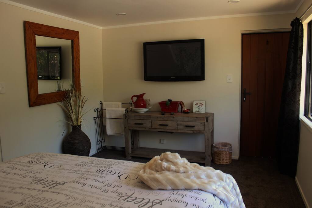 The view of bedroom and TV from the bed.