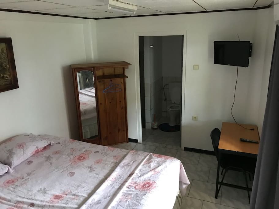 Here you can see a picture of the bedroom. As you can see it has a comfortable double bed, closet with miror and hangers, little desk and TV.