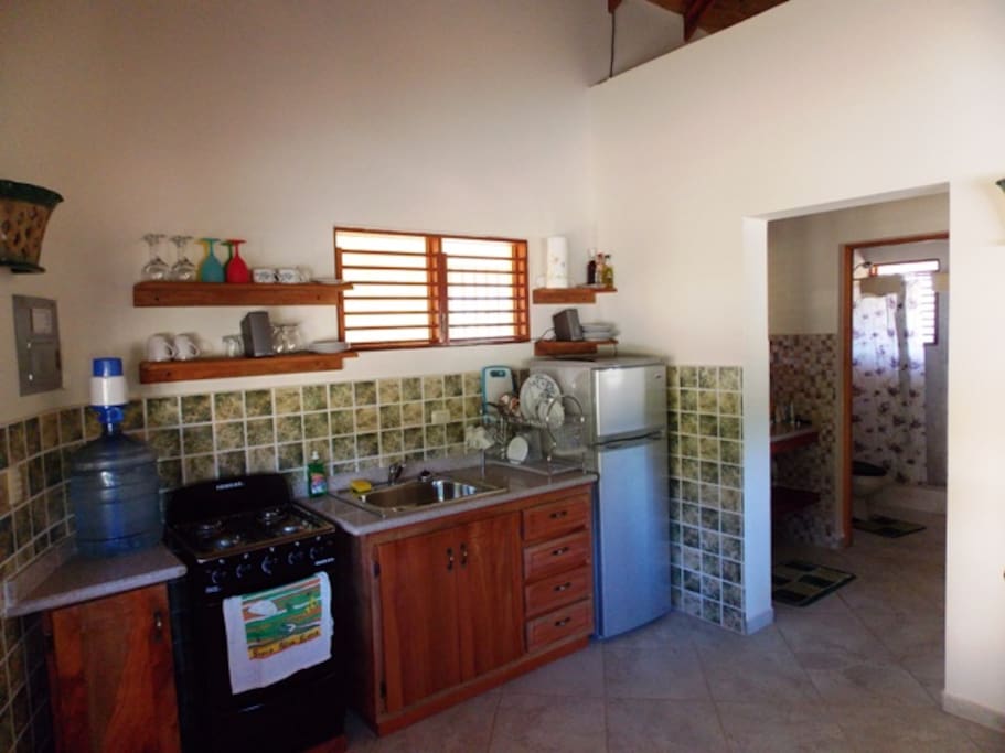 fully equipped kitchen with fridge and stove