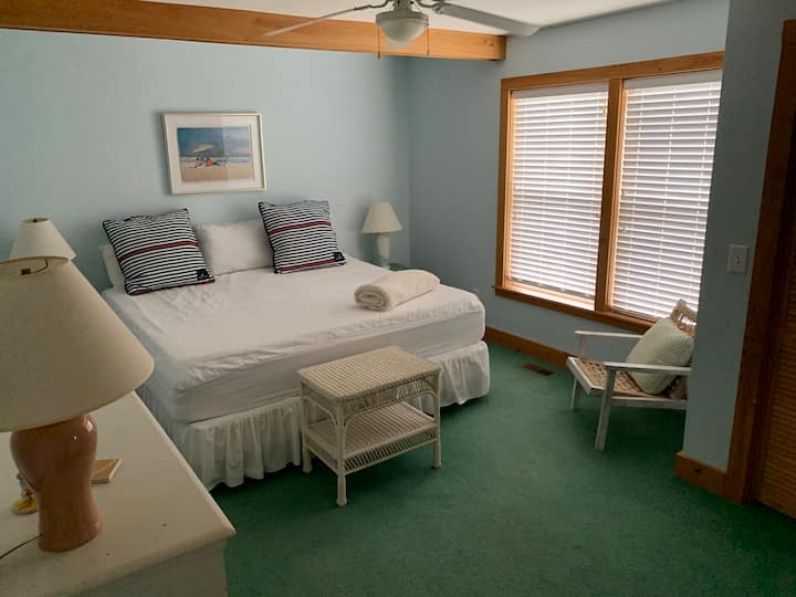 First floor, master bedroom suite, king size bed, and dedicated full bathroom. It's the only room in the whole house, which is carpeting, after one of the hurricanes, the original heart pine flooring could not be salvaged