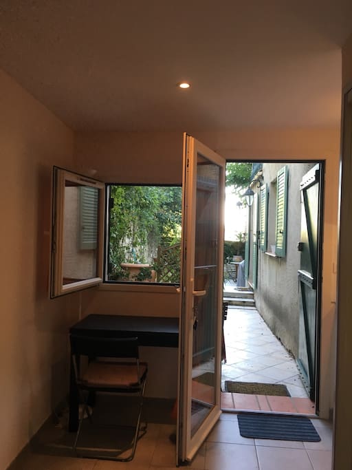 Entrance with expandable table and view to terrace.